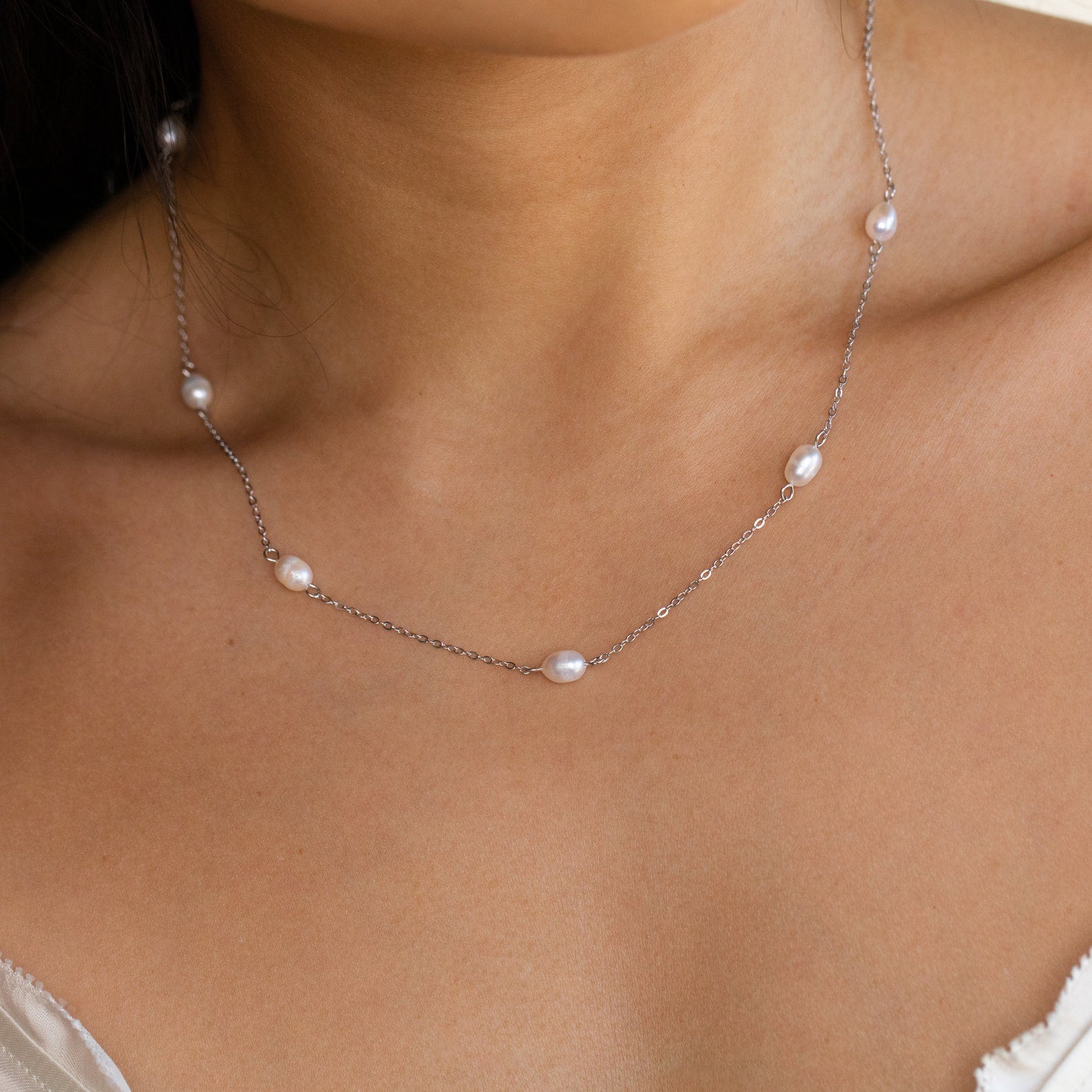 The Anna Pearl Station Necklace features delicately spaced pearls, making it an elegant gift choice for bridesmaids or Mother's Day.