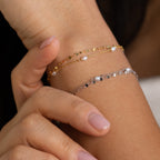 Female wrist wearing the Magnolia Pearl Wrap Bracelet, highlighting its layered pearl strands and subtle gold and silver against warm-toned skin.