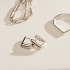 The Kelsey Link Earrings are displayed on a light surface—a minimal silver jewelry accessory for effortless, contemporary style.
