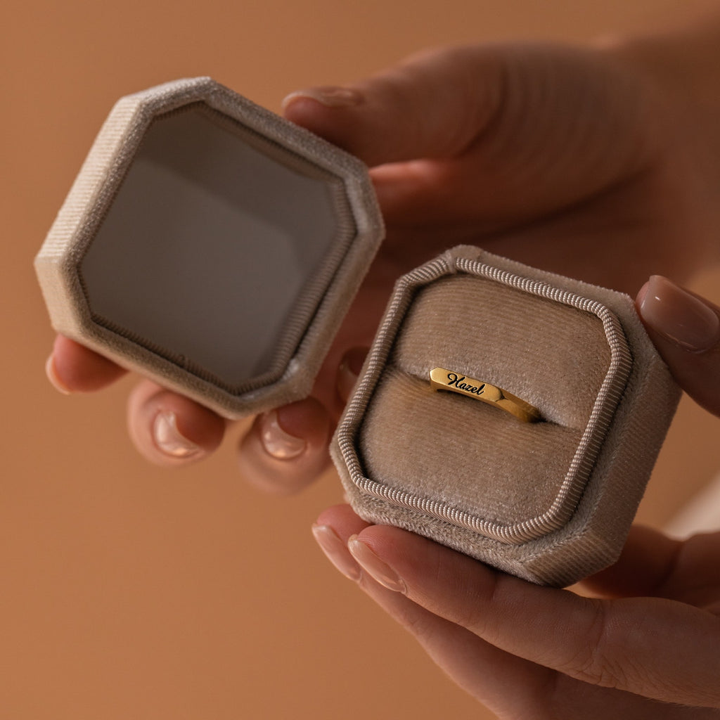 1 Slot Velvet Ring Box in beige octagonal shape with delicate trim, displaying gold ring against plush interior
