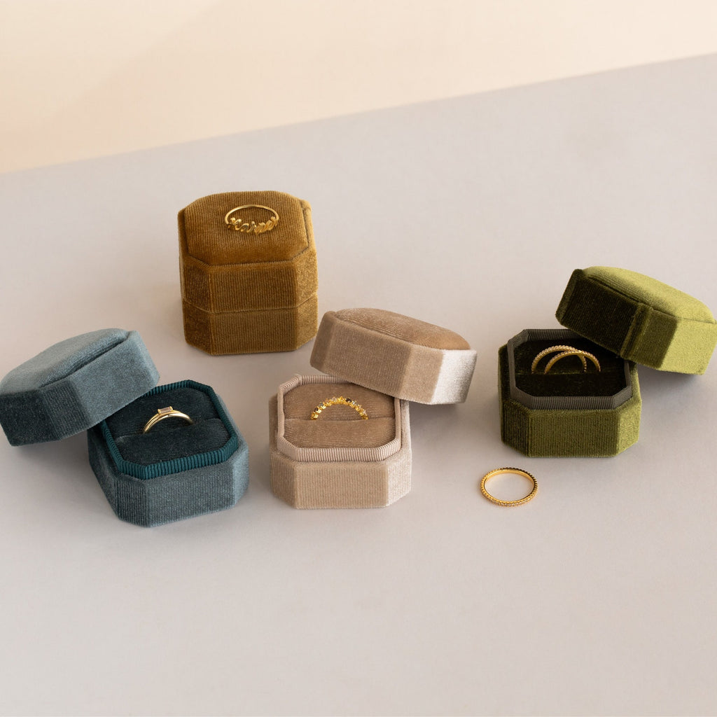 Velvet ring box in multiple colors with hexagonal shape, displaying delicate jewelry pieces and open boxes showing rings