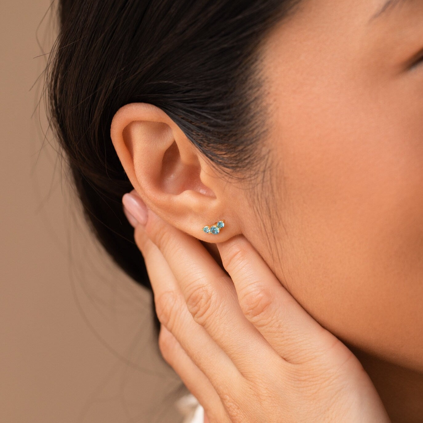 A close-up of a woman's ear wearing Bella Birthstone Studs, highlighting the elegance of personalized jewelry—an ideal gift for mothers and daughters.