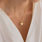 Close-up of a person wearing the Taylor Heart Paperclip Necklace, styled with a white V-neck blouse.