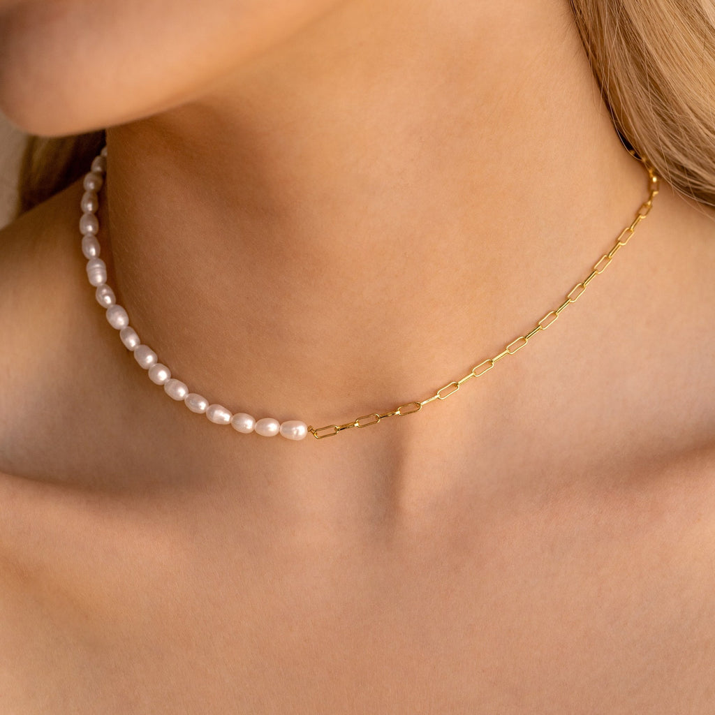 Close-up of a woman wearing the Pearl & Paperclip Chain Necklace styled as a choker, perfect for layering with your favorite pearl accessories.