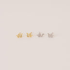 The Tiny Python Studs feature a chic snake design in gold and silver, adding subtle edge to your style. Perfect for boho-luxe earring lovers, these dainty studs are set against a light, neutral backdrop.