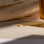 The Serafina Diamond Ring from our engagement collection, elegantly displayed on a cream surface under soft, warm lighting.