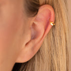  Side profile of a model wearing the butterfly cartilage huggie in her upper ear (cartilage), displaying how the small butterfly charm sits visibly on the cartilage.