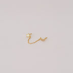 The Luna Moon & Star Chain Earrings feature gold star and moon studs linked by a delicate chain, creating unique chain stud earrings. Pictured on a simple light background.