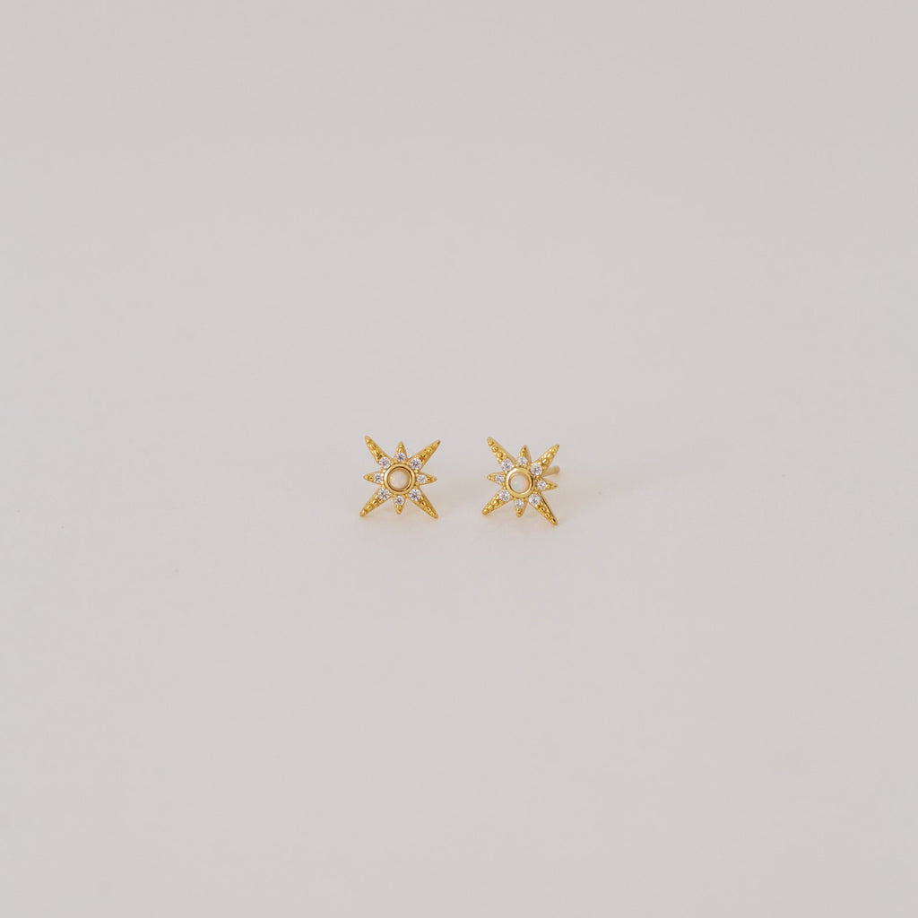 Starburst Studs featuring a central pearl, inspired by opal earring designs, shown on a plain light background.