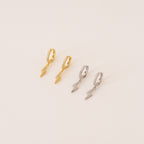 The Striker Pave Huggies, available in gold and silver lightning shapes, add a bold, trendy touch to any look—perfect for electrifying your style.