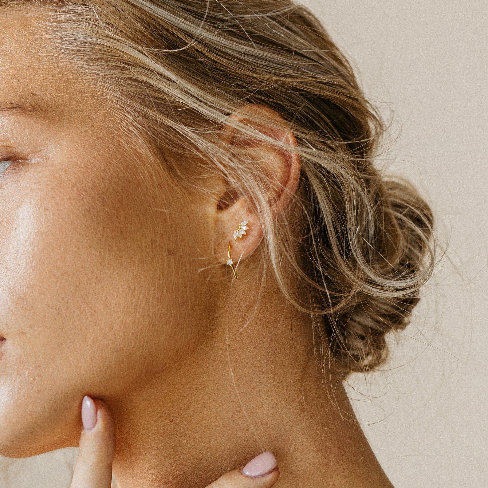 A close-up of a woman’s face showcases the elegant Odessa Marquise Studs—an ideal, thoughtful bridal gift.