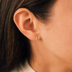 Close-up of a woman’s ear wearing Blair Baguette Diamond Drop Studs—ideal for those who appreciate minimalist, elegant earrings.