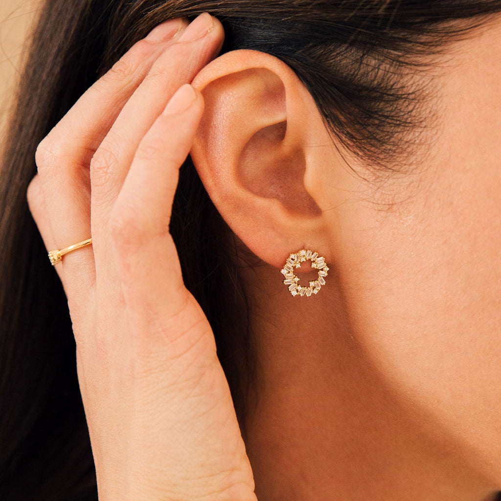 A close-up of a woman's ear adorned with the elegant Reina Cluster Studs.