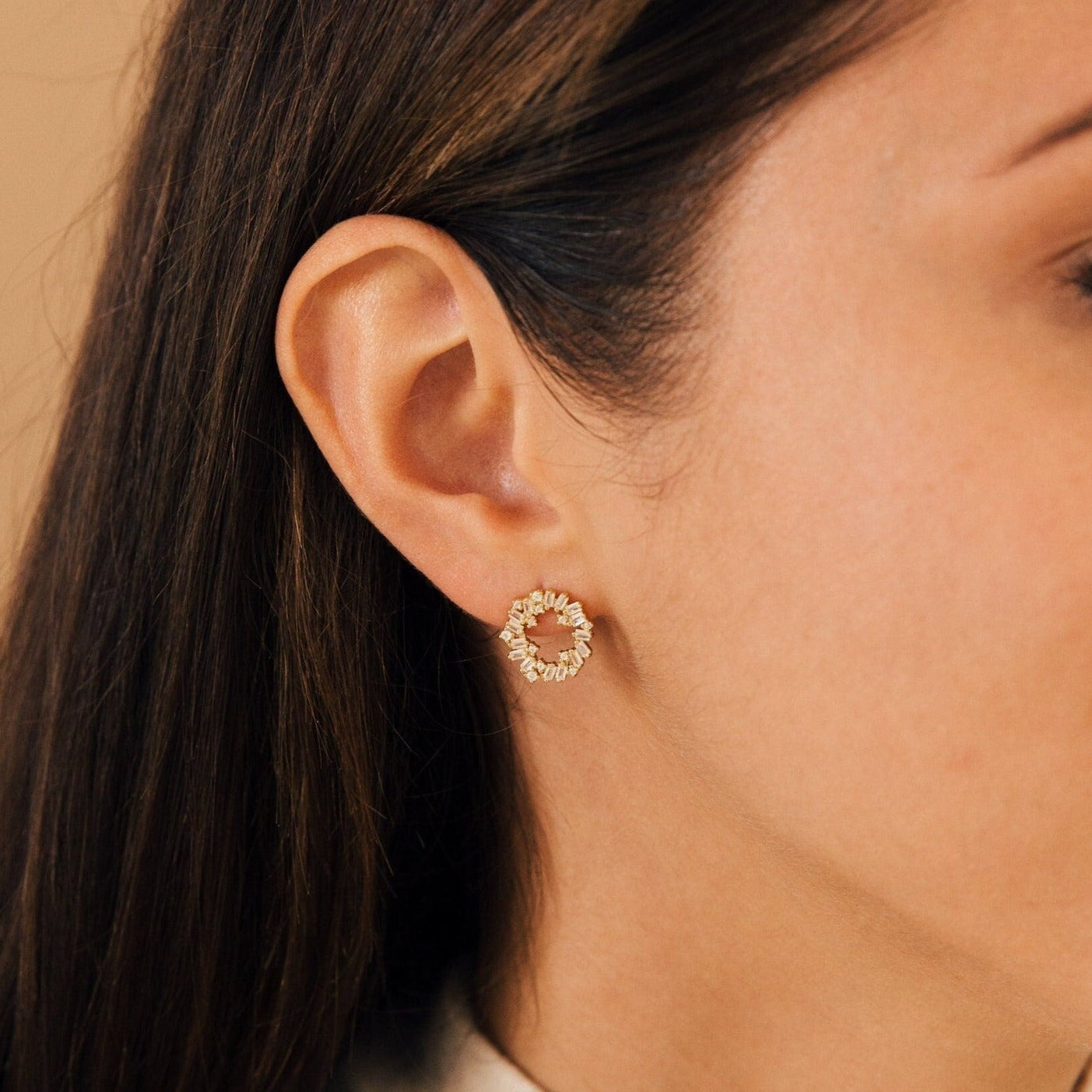 Close-up of a woman's ear wearing Reina Cluster Studs, gold circular wreath-shaped earrings, perfect as elegant bridal or statement wedding jewelry.
