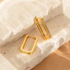 The Large Ribbed Link Hoops are showcased on textured stone surfaces in soft, natural lighting—ideal for fans of minimalist jewelry.