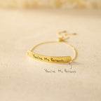 The Slider Handwriting Bracelet rests on a beige surface, engraved with "You're My Person." This personalized bracelet also includes your custom handwritten message below for a heartfelt touch.