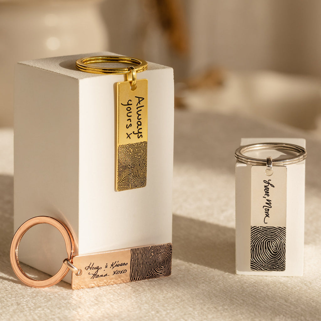 Three upright Fingerprint Bar Keychains with engraved fingerprints and custom handwritten messages—each unique keychain is a meaningful, personalized keepsake.