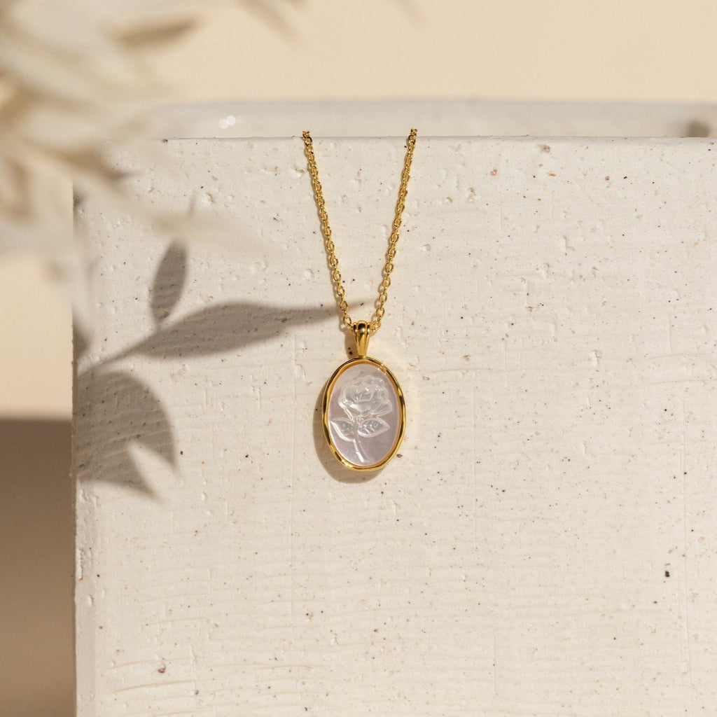 Vintage Rose Necklace with an oval white cameo pendant, shown on a textured white surface with soft shadows—a timeless piece, perfect as a thoughtful Mother’s Day gift.