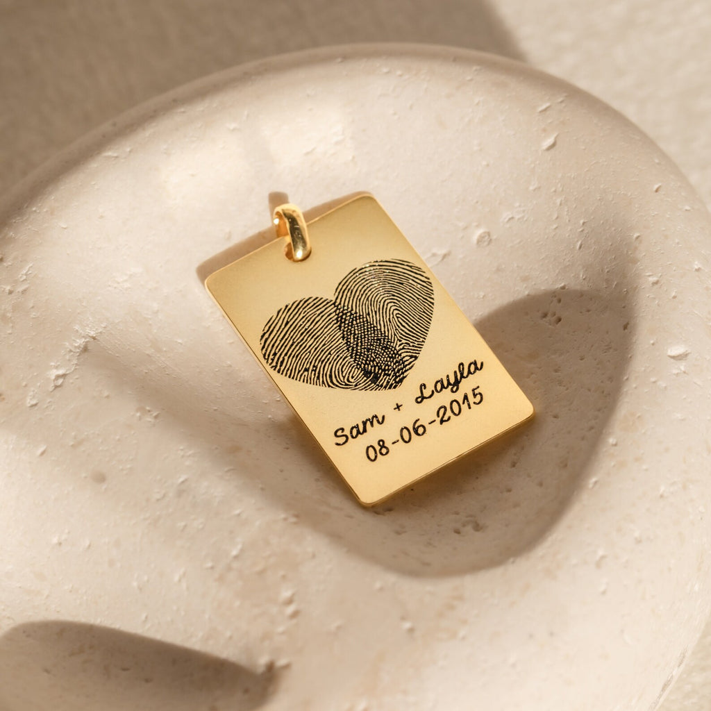 Fingerprint Rectangle Keychain engraved with two fingerprints forming a heart and Sam + Layla 08-06-2015—a personalized keepsake capturing your love and memories forever.