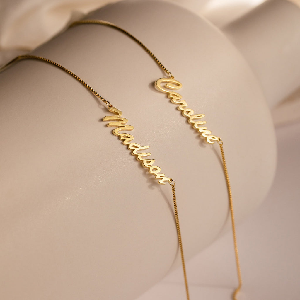 Two Natural Name Necklaces in Box Chain with custom Madison and Caroline pendants are displayed on a white surface—making a perfect personalized accessory and thoughtful gift.