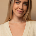 Model smiling  wearing the dainty irregular pearl choker, showing the necklace’s everyday elegance and choker fit.