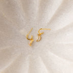 Opal Moon Mini Hoops, gold crescent-shaped earrings shown on a light textured surface—perfect for adding a touch of elegance to your earring stack.