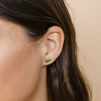 Close-up of a woman's ear wearing Triple Birthstone Studs—three small green bars arranged vertically. These stylish earrings make a perfect, thoughtful gift for mothers and daughters.