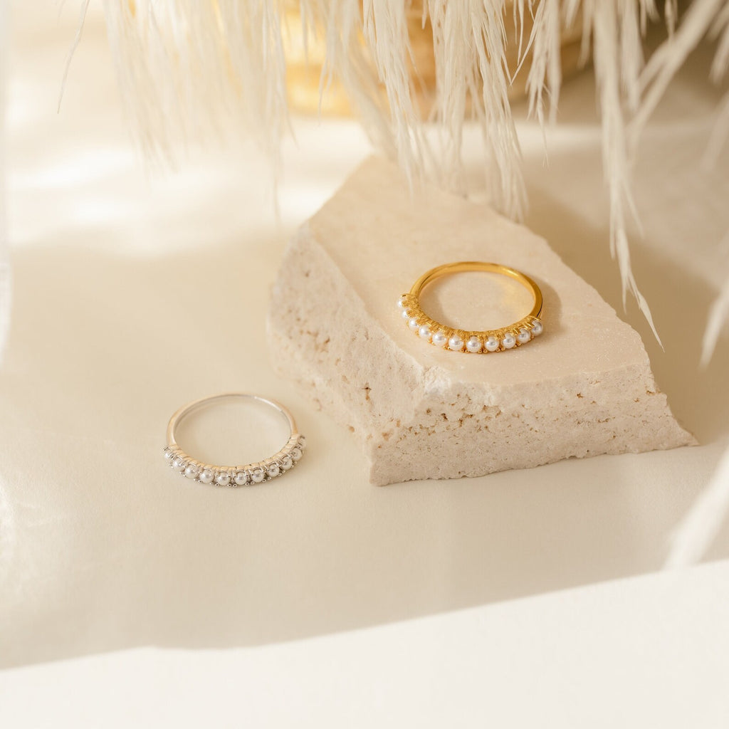 The Crescent Pearl Ring is displayed on a textured stone surface—perfect minimalist jewelry for a chic handmade stacking ring look.