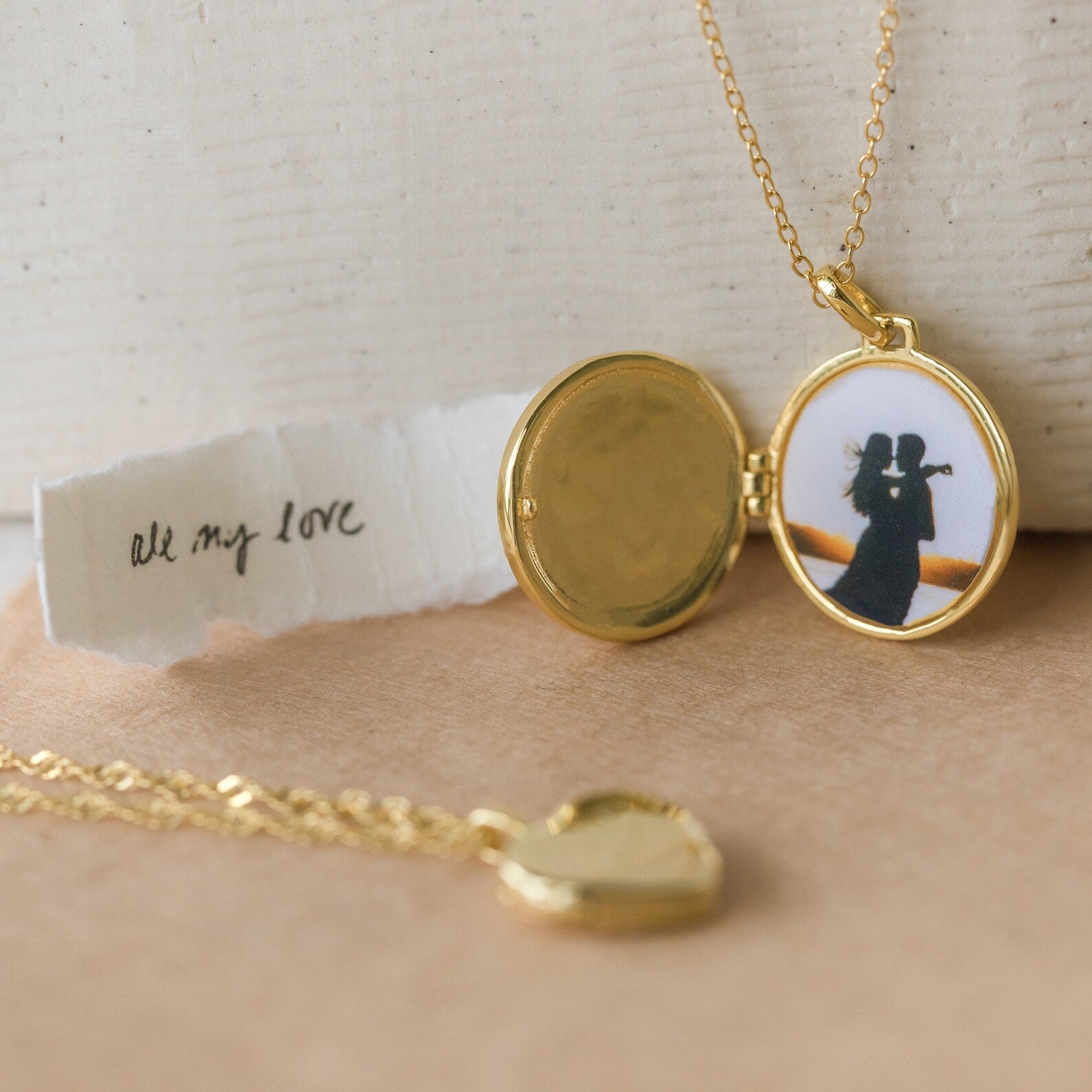 The Pearl Disc Locket Necklace, featuring a couple’s photo and a note reading "all my love," makes a meaningful gift to treasure forever.