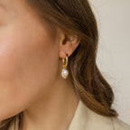 Close-up of a woman wearing the Pearl Drop Earrings Set—minimalist gold hoops with dangling pearls—ideal as elegant bridal earrings.