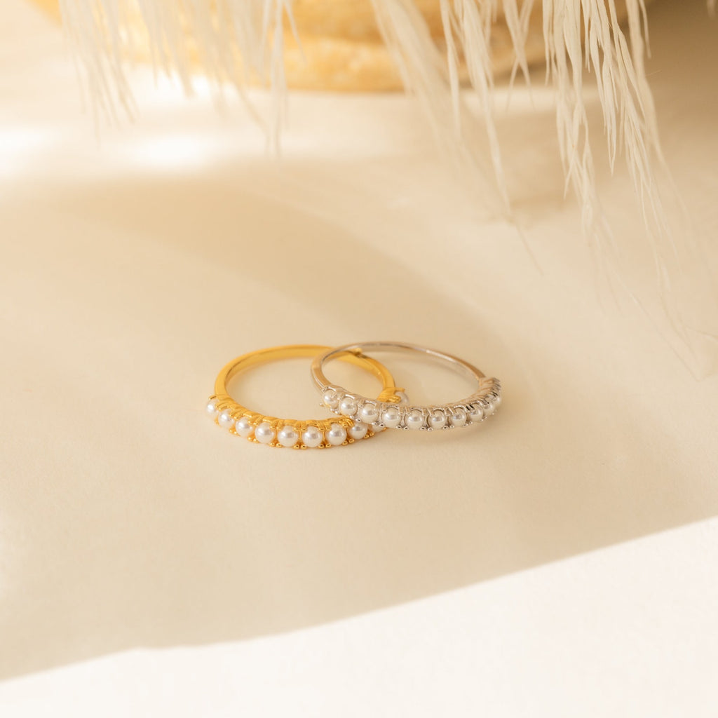 The Crescent Pearl Ring, available in gold and silver and adorned with small white pearls, is a perfect handmade stacking ring for minimalist jewelry lovers.