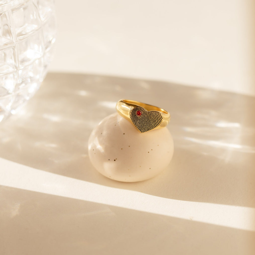 Fingerprint Heart Signet Ring, displayed on a round stone in gentle sunlight—a unique and meaningful gift for mom.