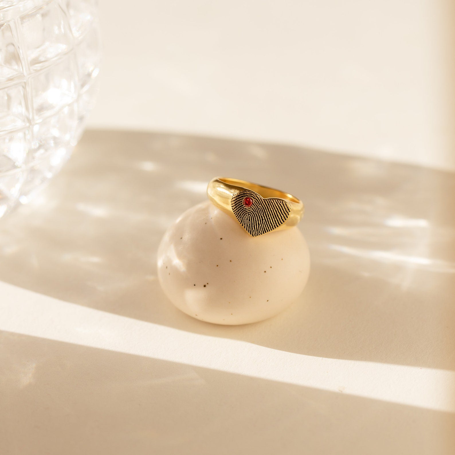 Fingerprint Heart Signet Ring, displayed on a round stone in gentle sunlight—a unique and meaningful gift for mom.