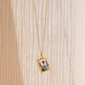 The Onyx Locket Necklace features a rectangular picture locket charm with a small black and white photo—an ideal choice for a personalized gift.