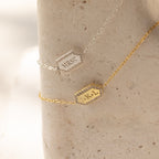 Two Custom Pave Hexagon Bracelets rest on stone—one silver engraved MRS♥, the other gold with J♥K L—making a thoughtful anniversary gift with personalized engraving.