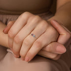 Close-up of hands wearing the Duo Vertical Baguette Ring, a delicate silver band with two colored gemstones on the ring finger—an ideal custom birthstone ring and personalized gift.