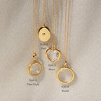 Four gold Crystal Locket Necklaces rest on fabric, each with a unique pendant shape: circle, oval, heart, and round. One locket is perfect for keeping special memories close.