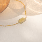 Custom Pave Hexagon Bracelet with a hexagonal pendant engraved with JMX, bordered by small clear stones—an elegant, personalized anniversary gift.