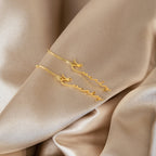Minimal Dangling Name Earrings spelling Everly are displayed on beige satin fabric—an ideal, unique gift for bridesmaids.