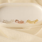 Old English Name Earrings: white rectangular display with gold and silver name tags, ideal for custom gifts or personalized inspiration.