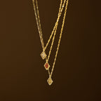 The Birthstone Diamond Pendant Necklace features a gold twisted chain and a diamond-shaped pendant with your choice of colored stone, making this handmade gemstone necklace perfect personalized jewelry for any occasion.