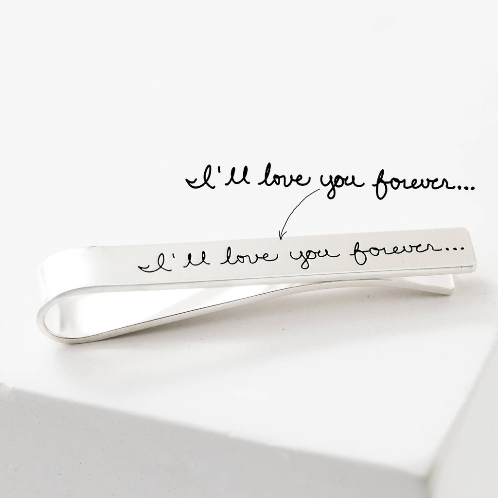 The Handwriting Tie Clip is a customizable silver tie clip engraved with "I'll love you forever..."—a unique, personalized gift for someone special.