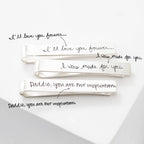 Three silver Handwriting Tie Clips, each engraved with a unique handwritten message: "I'll love you forever...", "I was made for you.", and "Daddy, you are our inspiration." The perfect personalized gift for any occasion.