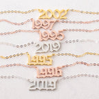 The Year Necklace features chains and pendants displaying 2002, 1997, 1995, 2019, and 1996—perfect as a birth year necklace or to add a unique gothic accessory to any outfit.