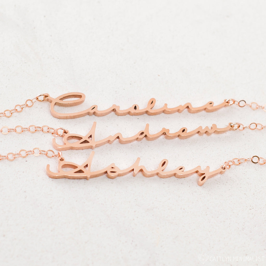 Three rose gold Minimal Name Necklaces—each personalized with Caroline, Andrew, and Ashley—displayed on a light background; perfect for lovers of dainty jewelry.