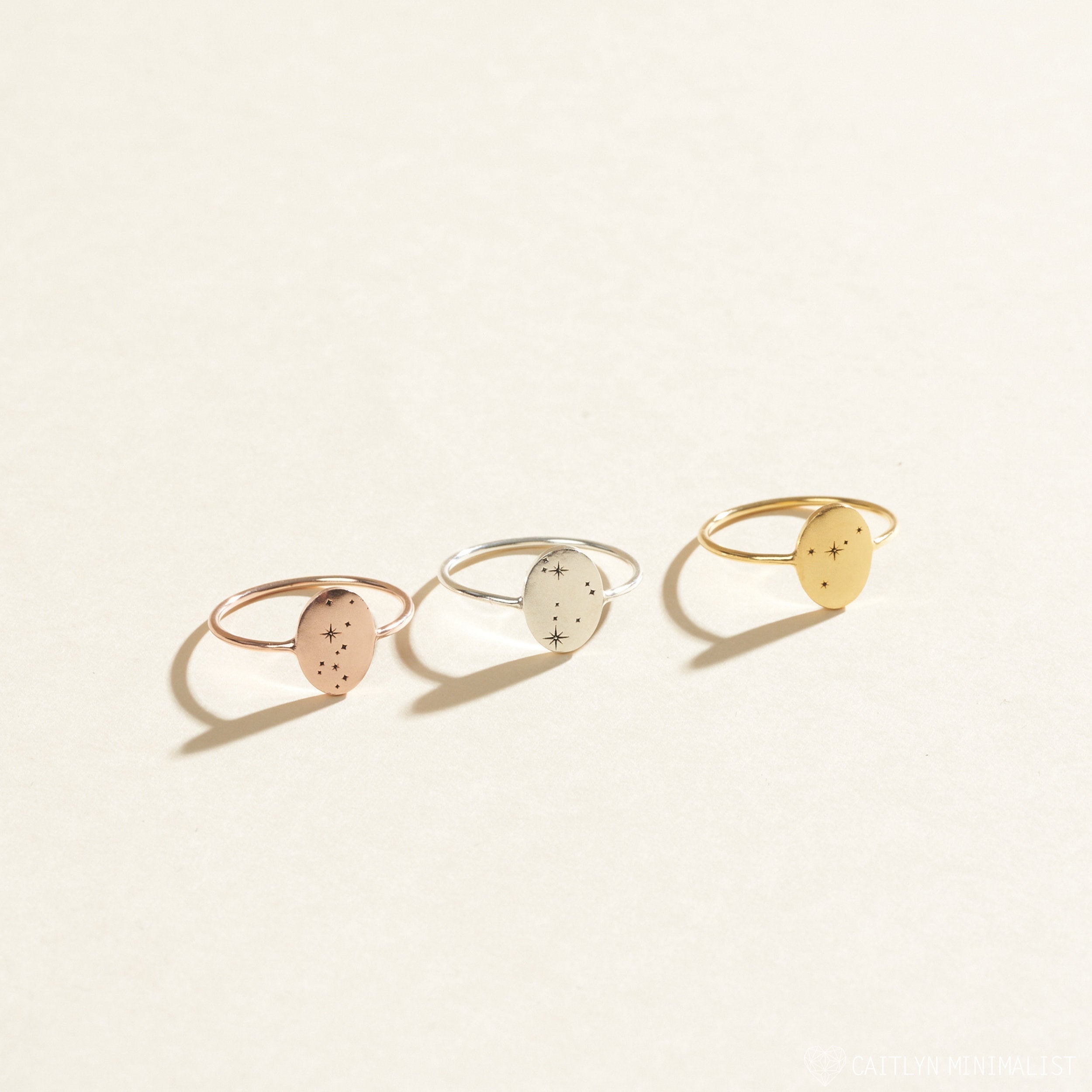 The Constellation Oval Ring features a minimalist oval design in rose gold, silver, and gold tones with constellation engravings—ideal Zodiac Signet Rings for anyone who loves unique zodiac jewelry.