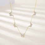 The Pave Butterfly Necklace features five diamond-encrusted butterfly pendants adorned with sparkling stones, elegantly displayed on a light background.