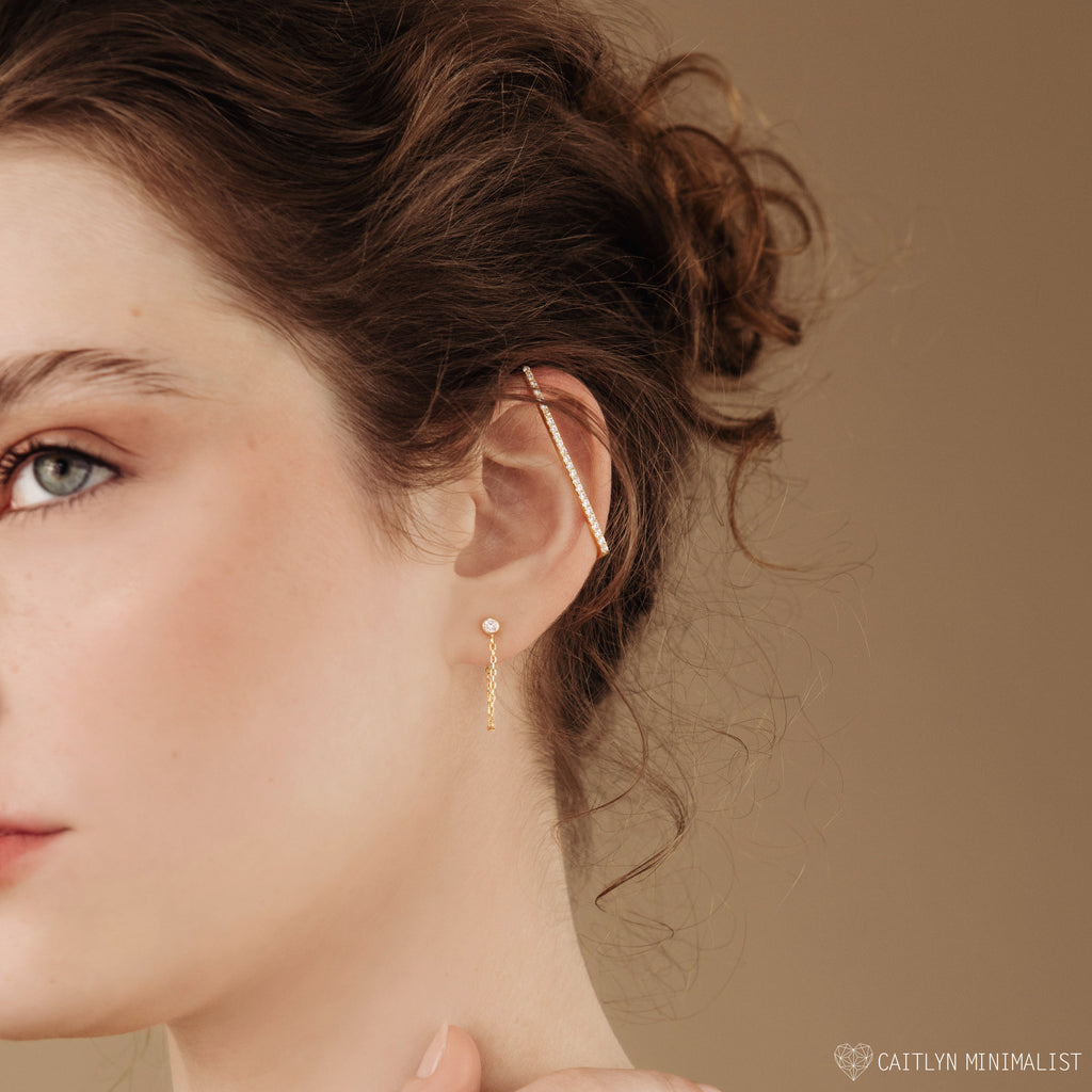 A woman wearing versatile jewelry: Birthstone Chain Studs, perfect for making a unique statement.