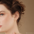 A woman wearing versatile jewelry: Birthstone Chain Studs, perfect for making a unique statement.