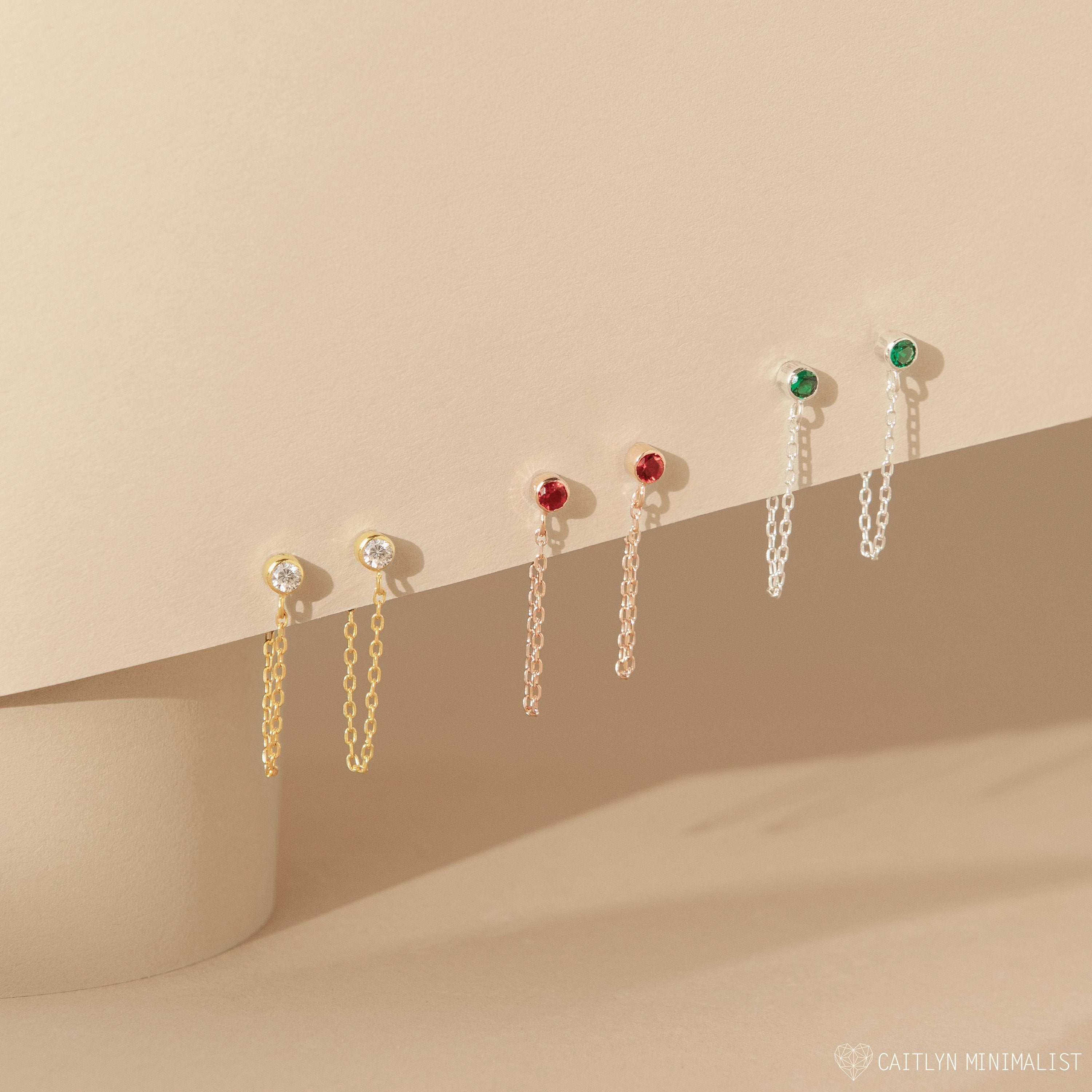 Elevate your style with Birthstone Chain Studs—three gold, rose gold, and silver pairs featuring clear, red, and green stones. This versatile set is a chic choice for you or a thoughtful personalized gift.